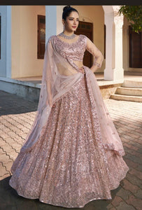 Designer lehenga in peach pink for wedding celebrations in London