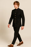 Side view of a black Jodhpuri suit with Bandhgala collar and welt pockets for a London reception