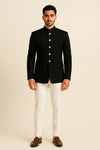 Full front view of black Bandhgala Jodhpuri suit with gold-tone buttons and ivory trousers for an Ahmedabad wedding