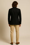 Back view of black Jodhpuri coat with contrasting tan trousers for an Oslo wedding celebration