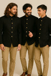 Three men wearing coordinated black Jodhpuri suits with tan trousers for a Berlin groomsmen look