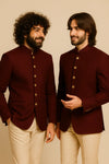 Two men in coordinated wine Bandhgala Jodhpuri suits and beige trousers for a Suva, Fiji wedding