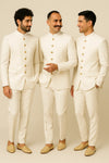 Three men wearing matching white Bandhgala Jodhpuri suits for a Dehradun wedding celebration