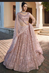 Designer lehenga in peach pink for wedding celebrations in London