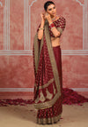 Maroon wedding saree with ornate golden border and traditional paisley detailing