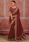 Maroon silk saree featuring detailed golden embroidery border and designer blouse