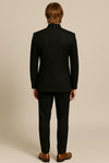 Back view of a black imported polyester Jodhpuri suit and matching trousers for a Delhi reception