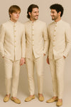 Three men wearing coordinated ivory Jodhpuri suits and matching trousers for a Hyderabad groom party