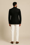 Back view of black Jodhpuri coat with contrasting ivory trousers for a London wedding guest look