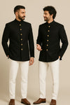 Two men in black Jodhpuri suits and ivory trousers, styled as close friends for a New Jersey reception