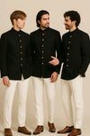 Three men in coordinated black Bandhgala Jodhpuri suits with ivory trousers for a Toronto wedding group