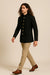 Side view of black Bandhgala Jodhpuri suit with gold-tone buttons and tan trousers for a Paris wedding reception