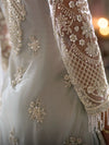Close-up of floral embroidery, sequins and hanging fringe on Ivory Silver kurta sleeve