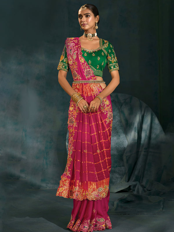 Front pose of model wearing a rani pink embroidered saree with heavy green blouse in Jaipur for Rajasthanis