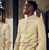 Designer Silk Sherwani in beige with dense resham work and mirror detailing