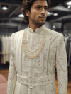 Custom made cream silk sherwani for an Indian groom handwork zari, resham, and moti work bharatplaza