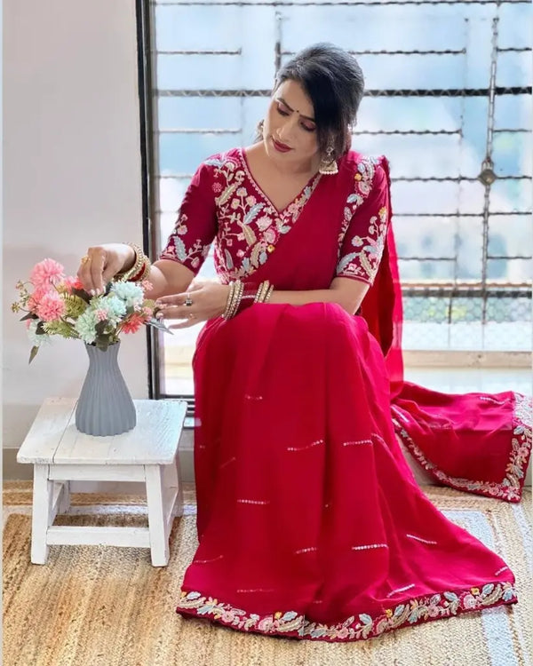 Rani Pink chiffon saree with embroidery border, model sitting pose