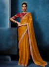 Mustard Fancy Fabric Designer Saree featuring a contrasting heavy red stitched blouse for festive wear | BharatPlaza