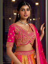 Pink and yellow Banarasi silk bridal lehenga with zari and crystal work for a grand Indian wedding in Dallas