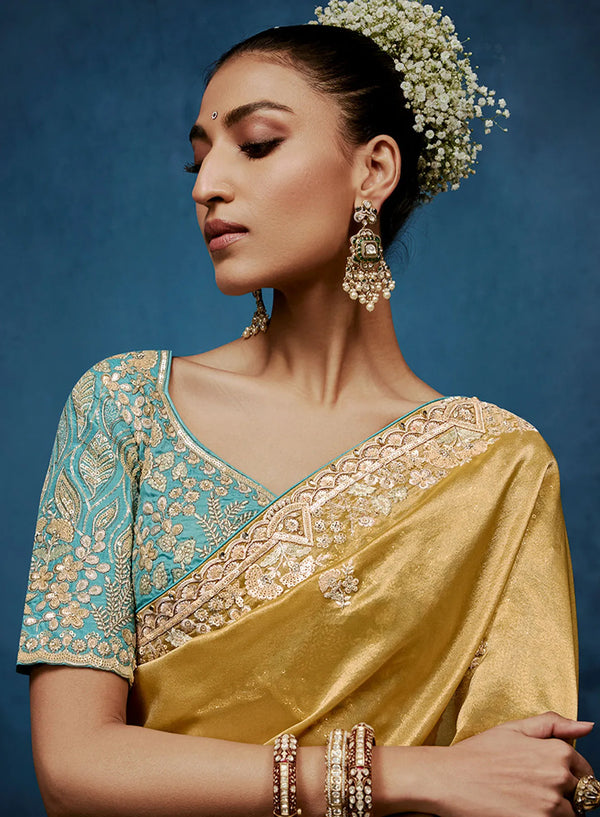 Gold Fancy Fabric Designer Saree featuring a contrasting heavy turquoise stitched blouse for festive wear | BharatPlaza